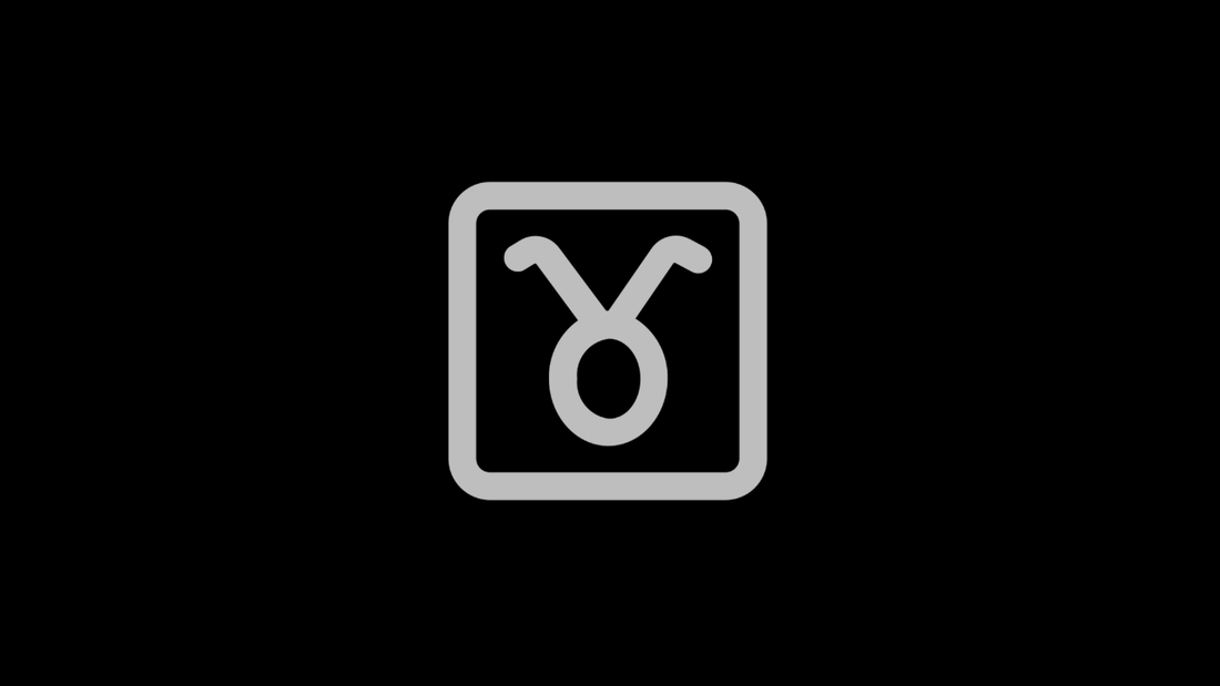 Gray Taurus zodiac symbol centered on a black background.